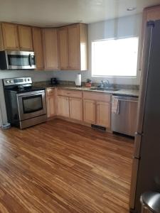 a kitchen with wooden cabinets and stainless steel appliances at 3 Bedroom By River Park & Trails in Loveland