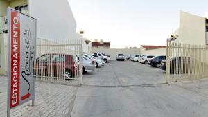 a parking lot with a bunch of parked cars at ROMA'S HOTEL in Umuarama
