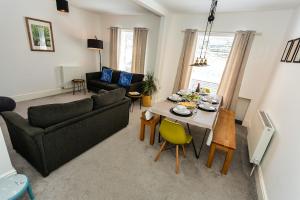 a living room with a table and a couch at St James By the Quay in Ilfracombe +64 photos