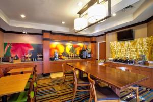 a dining room with a large wooden table and chairs at Fairfield Inn and Suites by Marriott McAllen in McAllen