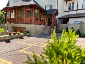 a house with a deck and a patio at Apartments Sonce in Truskavets