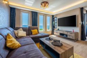 a living room with a couch and a tv at DOLLY LUX in Crikvenica +22 photos