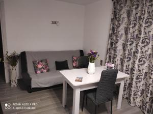 a living room with a table and a couch at Estella in Naxos Chora