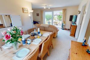 a living room with a table and a couch at CROYDE PEACH COTTAGE 3 Bedrooms in Croyde