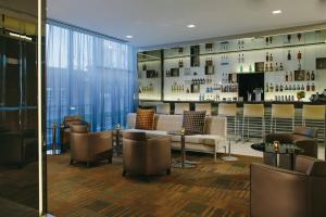 a lobby with a couch and chairs and a bar at AC Hotel Kansas City Plaza in Kansas City