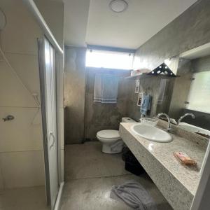 a bathroom with a toilet and a sink and a mirror at STUDIO 204 | WIFI 600MB | RESIDENCIAL JC, um lugar para ficar. in Belém