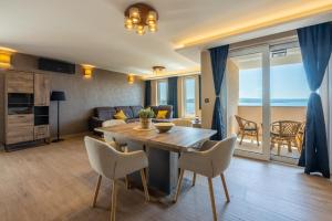 a living room with a wooden table and chairs at DOLLY LUX in Crikvenica