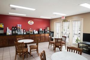 a restaurant with two tables and chairs and a counter at Super 8 by Wyndham Garner/Clayton/Raleigh in Garner