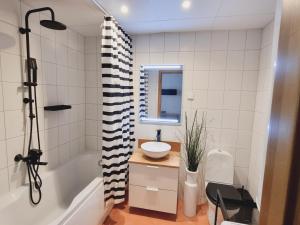 a bathroom with a tub and a sink and a toilet at A romantic seaside retreat for two in Meremõisa
