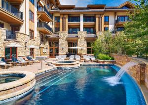 a pool with a fountain in the middle of a building at The Sebastian - Vail in Vail
