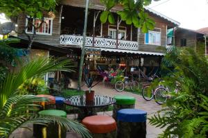 a patio with a table and chairs in front of a building at Spanish by the Sea - Bocas in Bocas del Toro