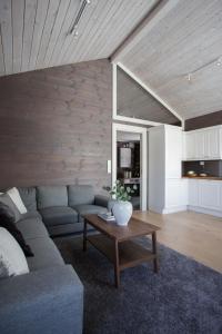 a living room with a couch and a coffee table at Penthouse apartment at Strandafjellet in Stranda