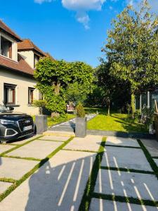a driveway with a car parked next to a house at Superbe maison avec jardin in Ris-Orangis