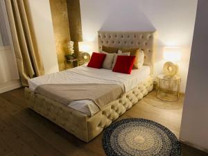 a bedroom with a large bed with red pillows at Superbe maison avec jardin in Ris-Orangis