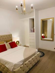 a bedroom with a large bed and a mirror at Superbe maison avec jardin in Ris-Orangis