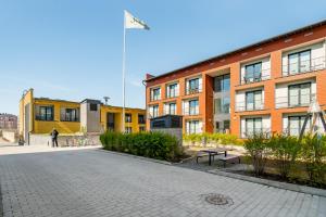a street in front of a building with a flag at Hiisi Homes Turku Fleminginkatu in Turku