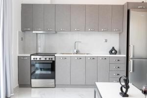a kitchen with stainless steel appliances and a sink at Z5 Sky Sparta Apartment in Sparta