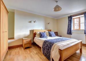 a bedroom with a large bed and a window at Hen Ysgubor in Lampeter