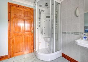 a bathroom with a shower and a sink at Beudy Bach in Lampeter +18 photos