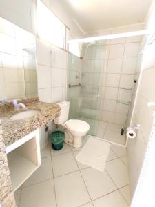 a bathroom with a toilet and a sink and a shower at Amazônia Praia Hotel in Tibau