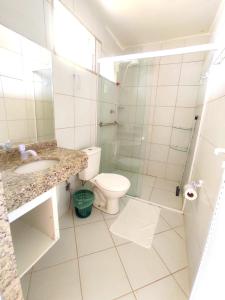 a bathroom with a toilet and a sink and a shower at Amazônia Praia Hotel in Tibau +39 photos