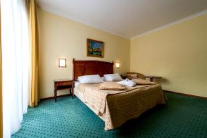 Postel nebo postele na pokoji v ubytování Hotel Churchill