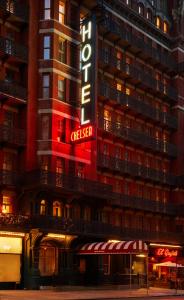 a hotel building with a neon sign on it at The Hotel Chelsea in New York