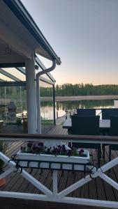 a patio with a table and chairs on a deck at Arolahti Suite ( Rapojärvi ) in Kouvola