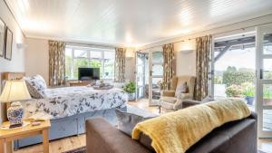 a bedroom with a bed and a couch at The Gite in Oystermouth