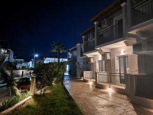 a night view of a house with a driveway at Cavo Garden in Kavos
