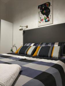 a bedroom with two beds with striped sheets at Francesco Romestay - Termini in Rome