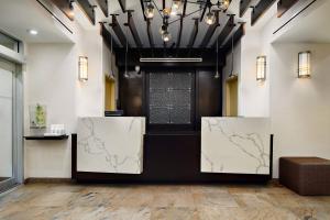 a lobby with two screens with maps on them at Fairfield Inn & Suites by Marriott New York Manhattan/Chelsea in New York