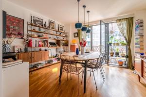 a kitchen and dining room with a table and chairs at Stylish Hackney Wick Home in London