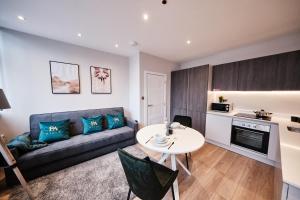 a living room with a couch and a table at Pluxa Jade - Prime Harrow, Work Desk & WiFi in Harrow