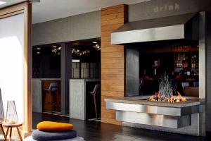 a fireplace in a restaurant with a fire place at Renaissance Minneapolis Bloomington Hotel in Bloomington