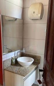 a bathroom with a white bowl sink on a counter at Pousada Plantar e Cuidar in Santa Cruz do Escalvado