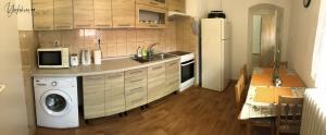 a kitchen with a refrigerator and a washing machine at Apartment Yorkshire in Bujanov