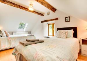a bedroom with a large bed and a window at Crud y Werin in Llandderfel