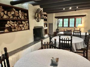 a dining room with two tables and a fireplace at Hacienda Del Sol in Taos