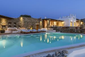 a swimming pool in a villa at night at Villa Yasmina in Tourlos
