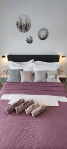 a large bed with two pairs of shoes on it at Rooms Lucky in Makarska