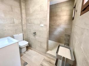 a bathroom with a toilet and a shower at Benidorm Old Town House with lounge area in Benidorm
