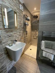 a bathroom with a white sink and a shower at Saorsa House Culross in Fife