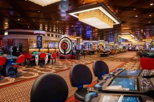 a casino with poker tables and chairs in a casino at HoteLumiere at the Arch in Saint Louis