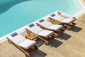 an overhead view of lounge chairs and a swimming pool at Villa Yasmina in Tourlos