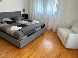 a bedroom with a large bed and a couch at Doge Beato Apartment in Venice-Lido
