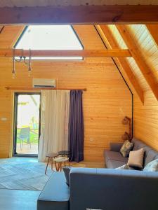 a living room with a couch and a window at El-Ya Bungalov ve pansiyon in Dalaman