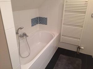 e bagno con vasca bianca e doccia. di Horský apartmán s výhledem na Lysou horu a Rokytnice nad Jizerou Altre 22 foto