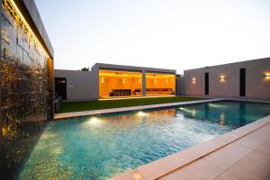 a swimming pool in the backyard of a house at La Terra Chalets 2 in Jeddah
