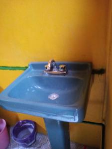 a blue sink in a bathroom with a yellow wall at 224 in Oaxaca City